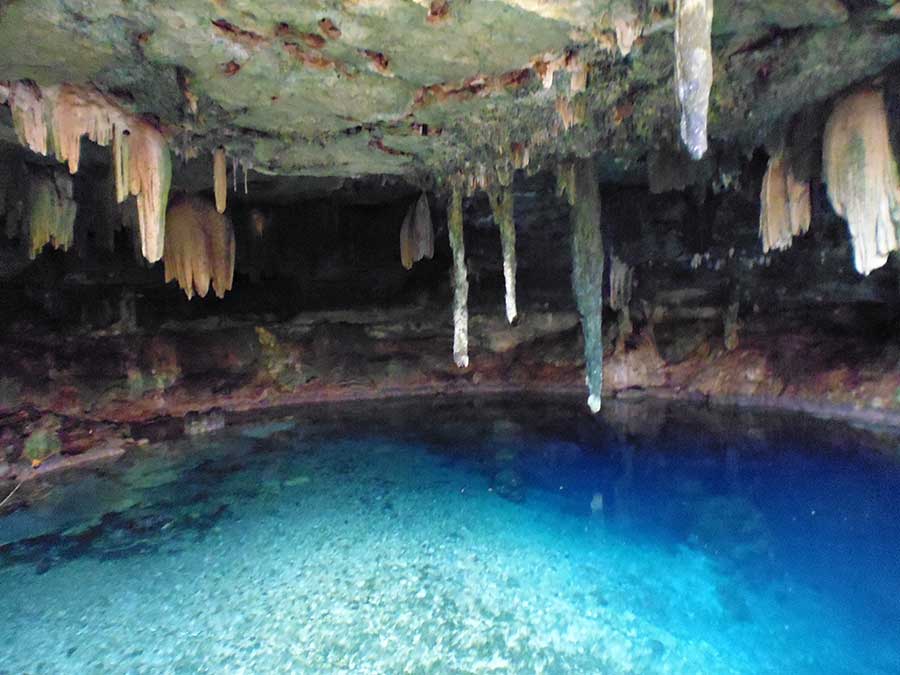 Best Cenotes in the Yucatan- Cenote Kankirixche with stalactites hanging above the water