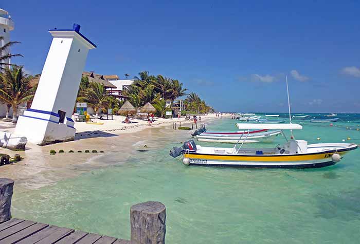 Reasons to visit Mexico - Caribbean Beach at Puerto Morelos with boats