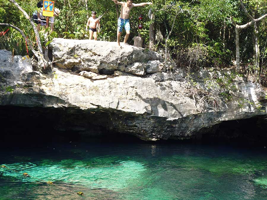 Best Cenotes in the Yucatan - People jumping off the cliff at Cenote Azul