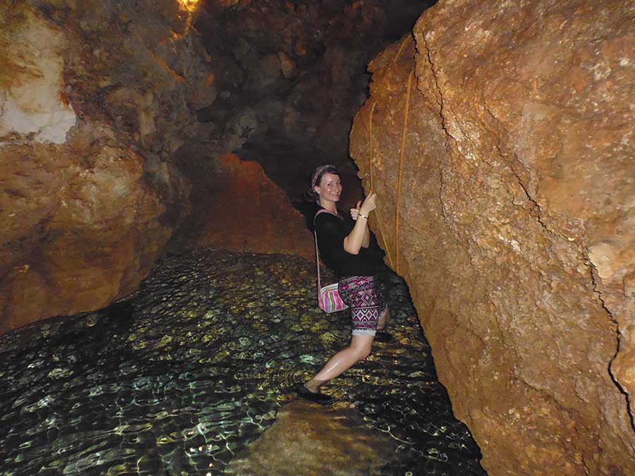 Best Cenotes in the Yucatan - Grotto and Cenote La Canderia - clambering along the edge of the cenote using the rope