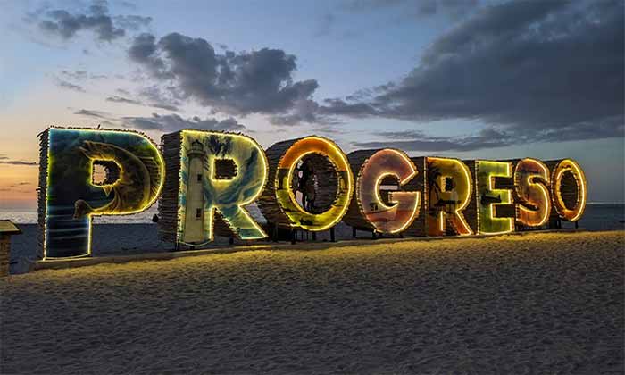 day trips from Merida to Progreso sign at night