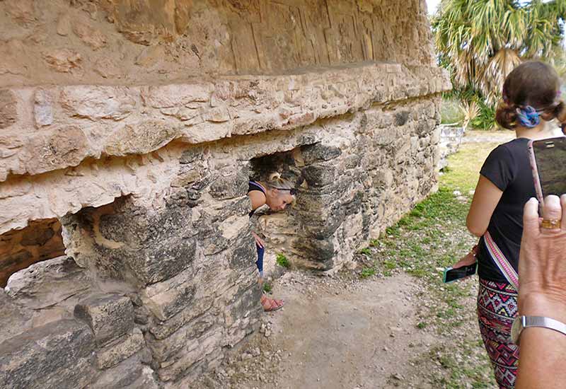 Exploring the Acropolis and its small doorways while visiting Acanceh Mayan Ruins