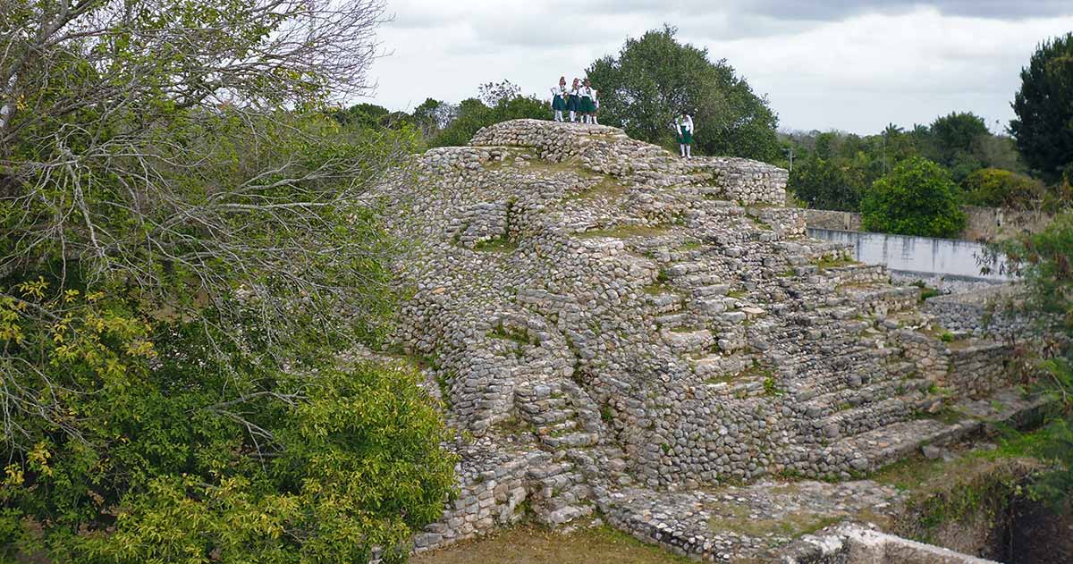 School tour Climbing the Second Pyramid while visiting Acanceh Mayan Ruins